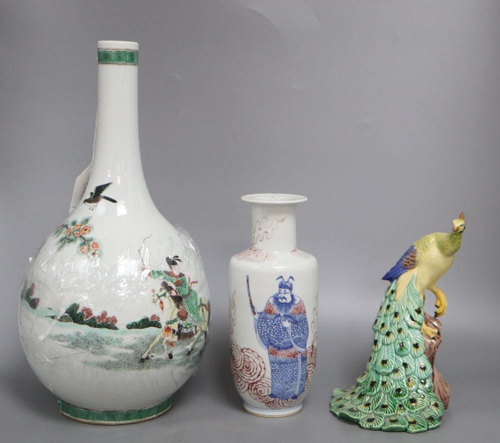 A Chinese famille verte bottle vase, an underglazed copper rouleau vase and a peacock, tallest 38cm